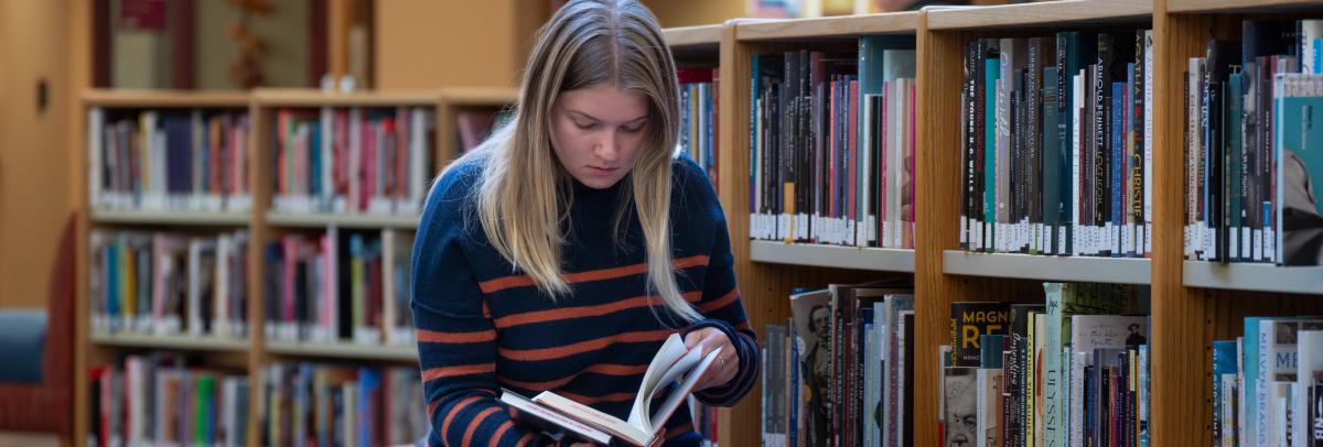 A student reading a book at AAC library